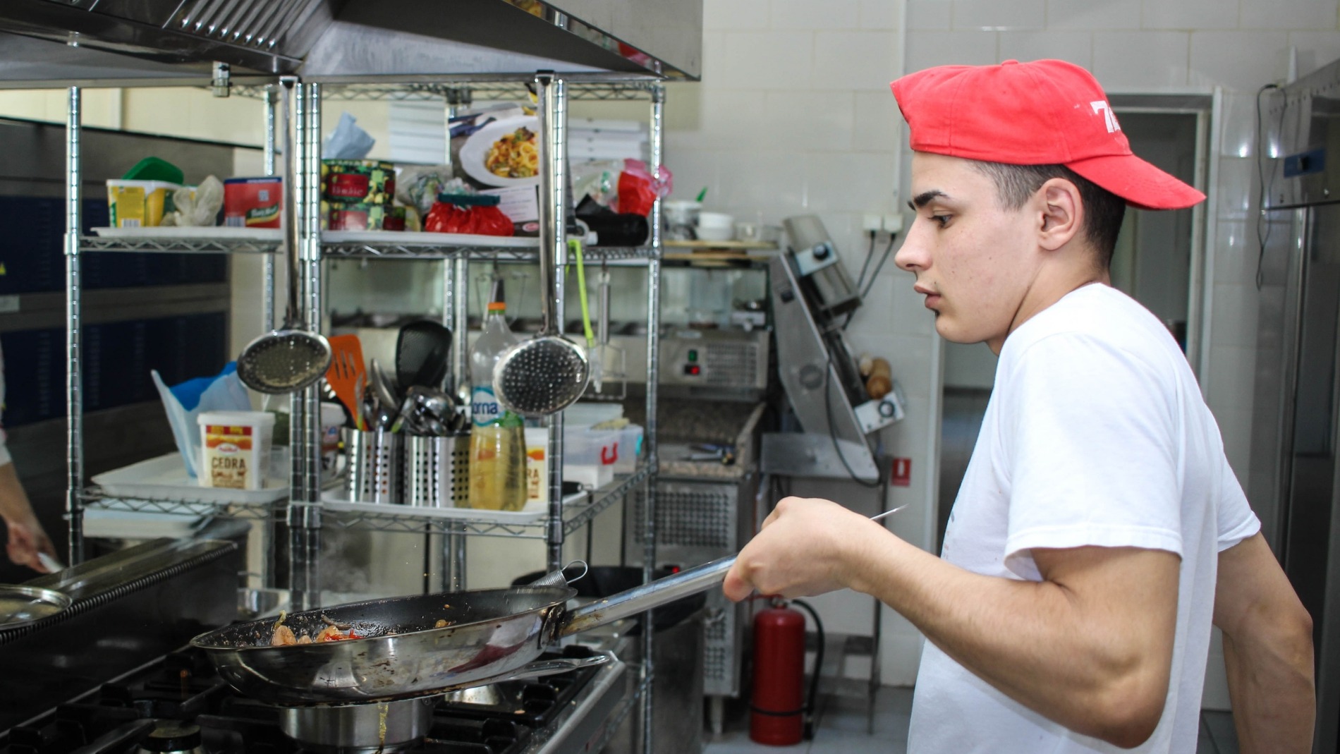 Young person cooking in a professional kitchen